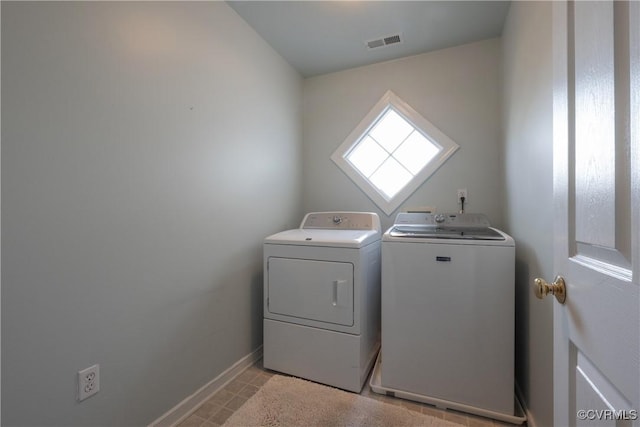 laundry area featuring washer and dryer, laundry area, visible vents, and baseboards