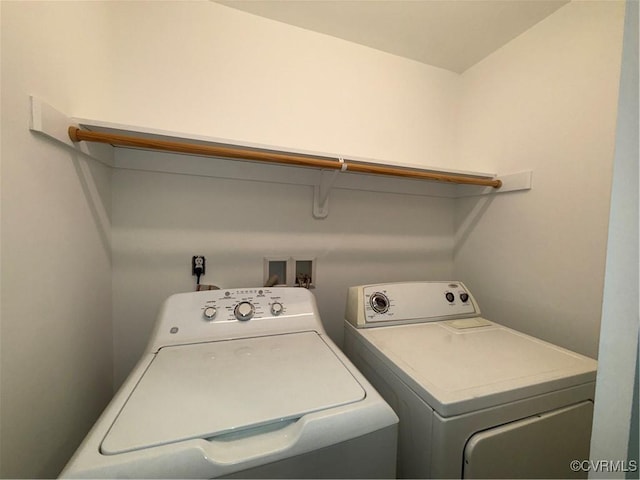 clothes washing area with washer and clothes dryer