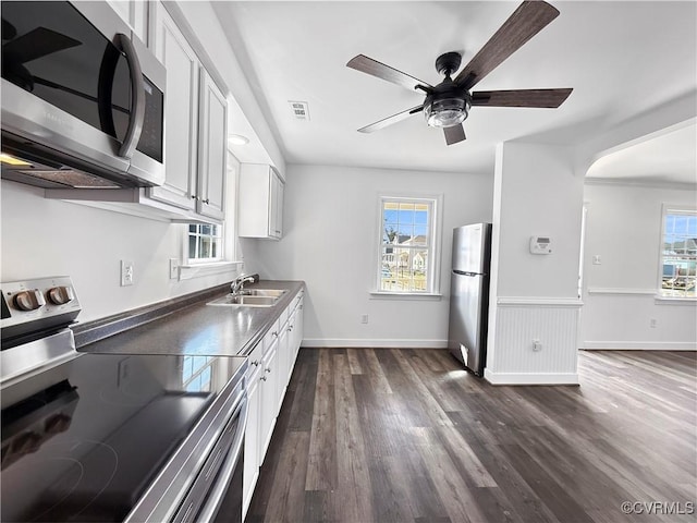 kitchen featuring white cabinets, a healthy amount of sunlight, stainless steel appliances, and sink