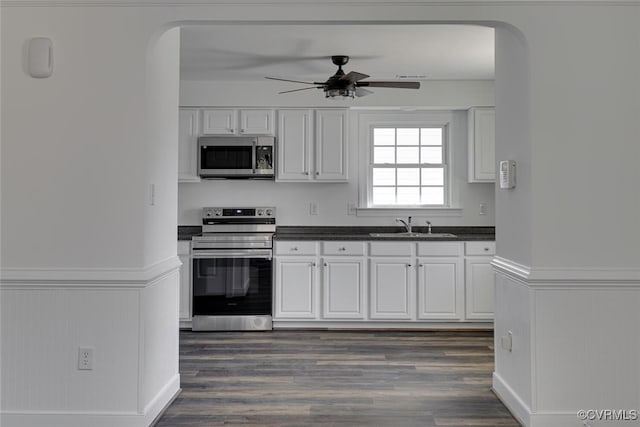 kitchen featuring sink, ceiling fan, stainless steel appliances, dark wood-type flooring, and white cabinets