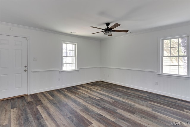 empty room featuring dark wood-type flooring, crown molding, and ceiling fan