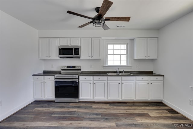 kitchen featuring white cabinets, stainless steel appliances, dark hardwood / wood-style floors, and sink