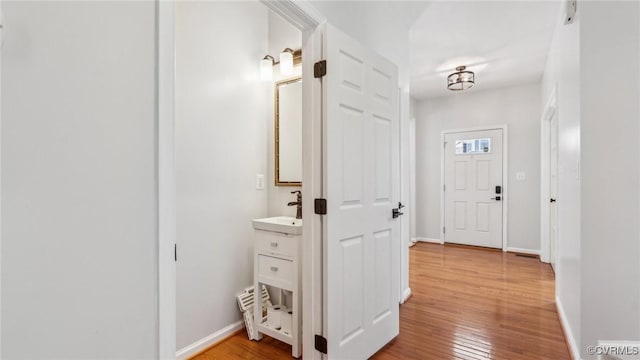 interior space with sink and light hardwood / wood-style floors