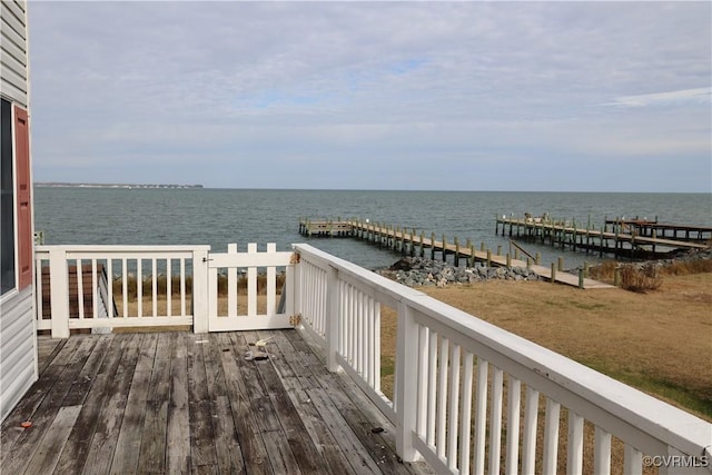 wooden terrace featuring a water view and a dock