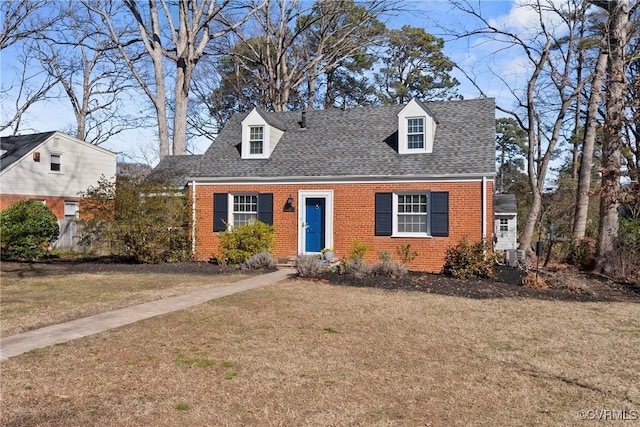 new england style home with a front lawn