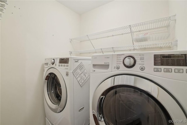 laundry area featuring washing machine and clothes dryer