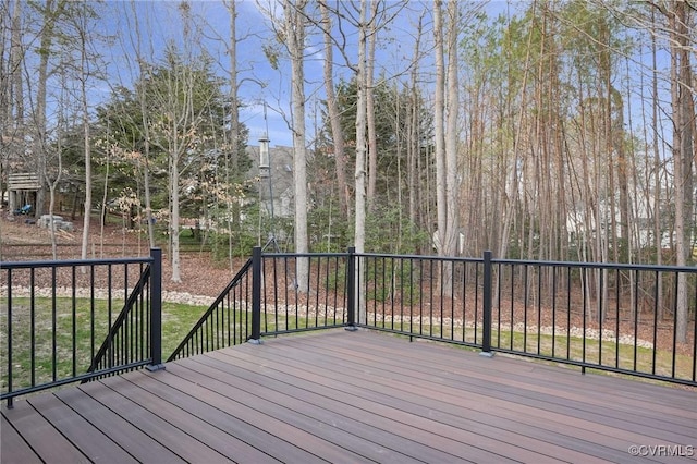 wooden deck featuring a lawn