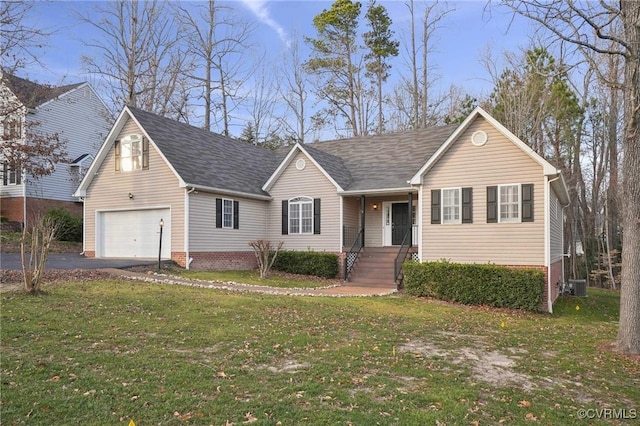 view of front of home with central AC, a front yard, and a garage