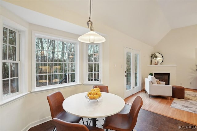 dining space with lofted ceiling and hardwood / wood-style flooring