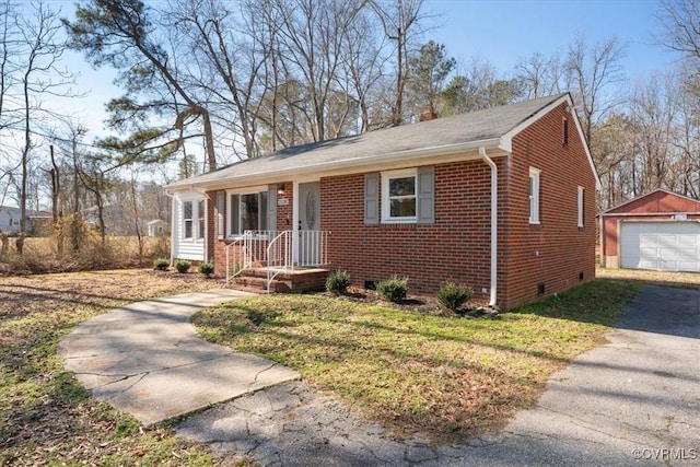 view of front of home with a front yard, an outdoor structure, and a garage