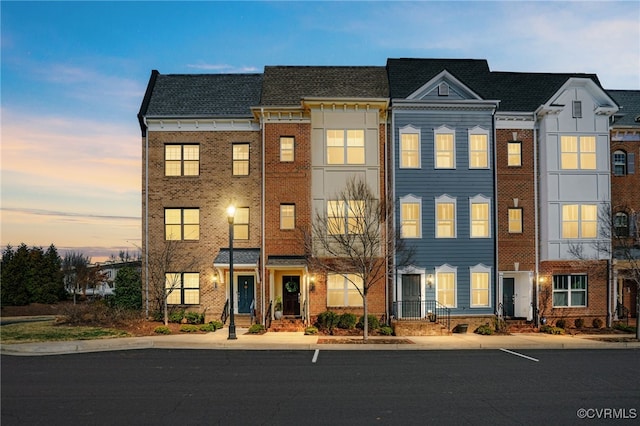 view of property featuring brick siding