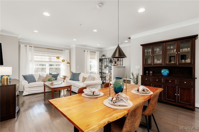 dining space featuring recessed lighting, crown molding, and wood finished floors