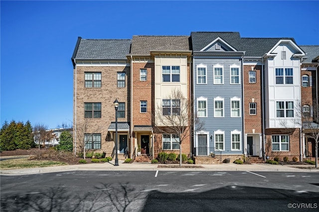 view of front of property with a residential view and brick siding