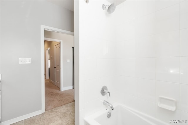 full bath featuring tile patterned floors, bathing tub / shower combination, and baseboards