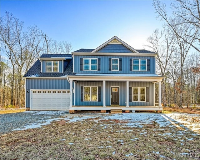 view of front of house with a porch, driveway, a garage, and board and batten siding