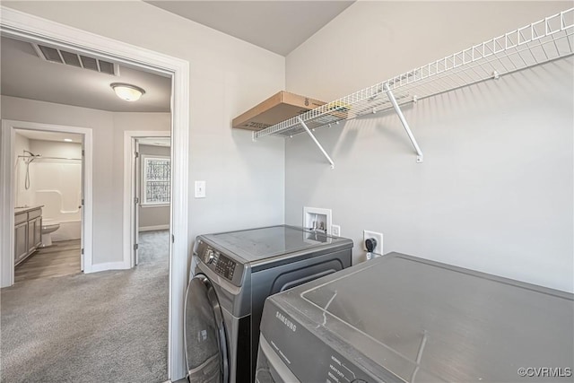 laundry area with carpet, baseboards, visible vents, laundry area, and separate washer and dryer