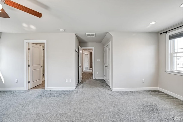 unfurnished bedroom featuring visible vents, ceiling fan, baseboards, and carpet