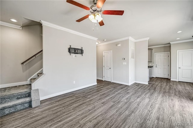 unfurnished living room with stairway, baseboards, wood finished floors, and ornamental molding