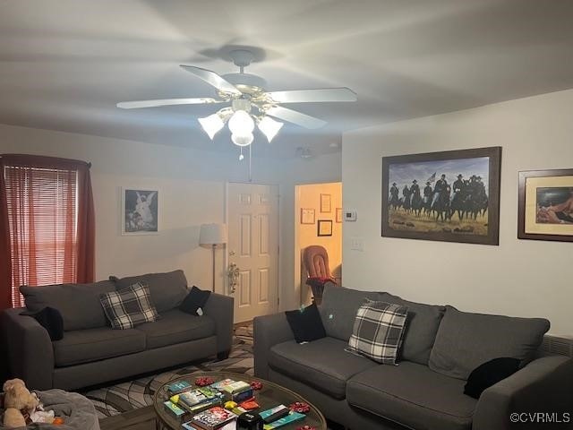 living area featuring a ceiling fan