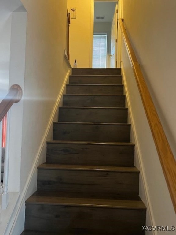 stairway with a healthy amount of sunlight and visible vents