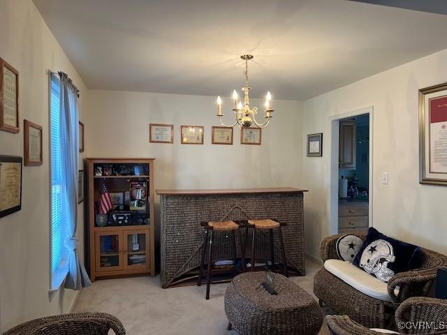 interior space with a bar, carpet, and a notable chandelier