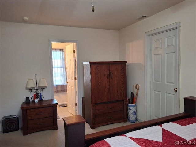 bedroom featuring visible vents and ensuite bath