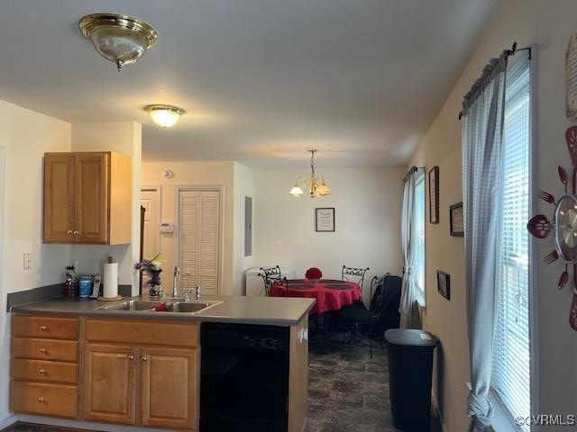 kitchen featuring a notable chandelier, hanging light fixtures, a sink, black dishwasher, and a peninsula