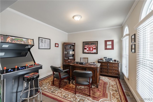 office space with baseboards, wood finished floors, visible vents, and crown molding