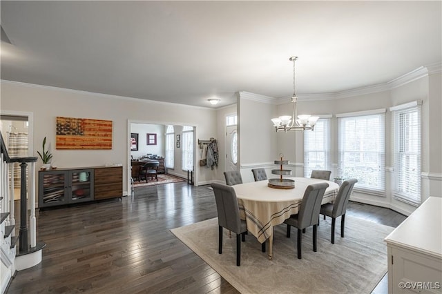 dining area with dark wood-style floors, crown molding, stairs, and an inviting chandelier