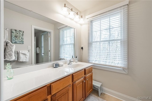 bathroom featuring vanity, baseboards, and tile patterned floors