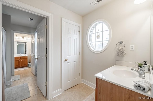 full bathroom featuring tile patterned flooring, visible vents, and vanity