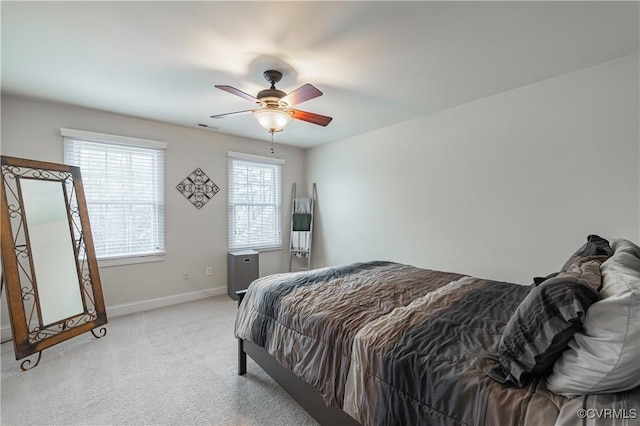 bedroom featuring light carpet, visible vents, baseboards, and a ceiling fan