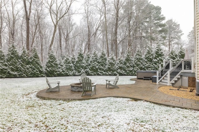 exterior space with a fire pit and a hot tub