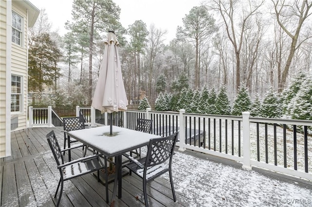 wooden terrace with outdoor dining area