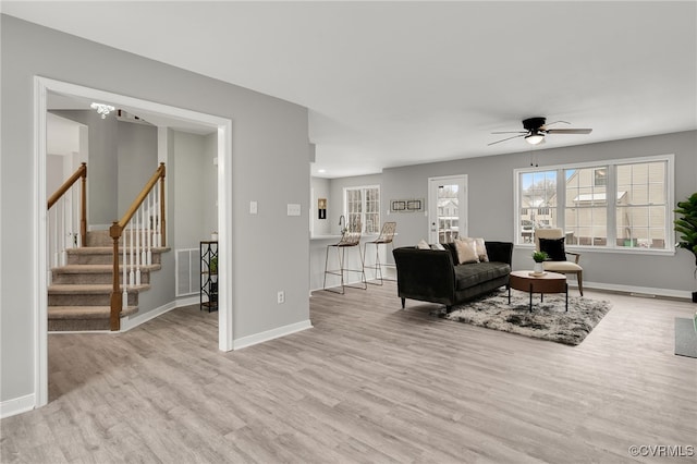 living room with ceiling fan and light wood-type flooring