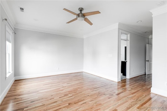 unfurnished room featuring ceiling fan, light wood-type flooring, baseboards, and crown molding