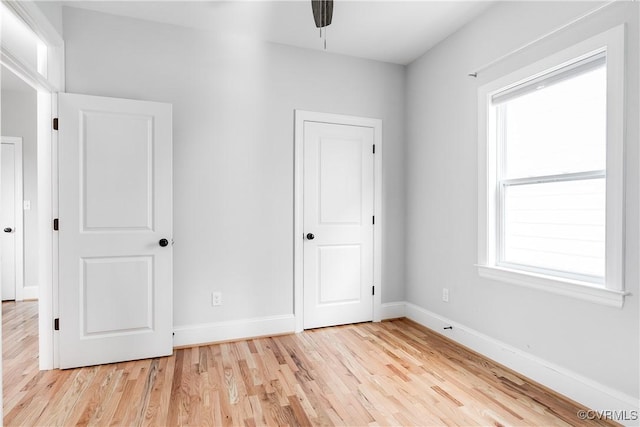 unfurnished bedroom with light wood finished floors and baseboards