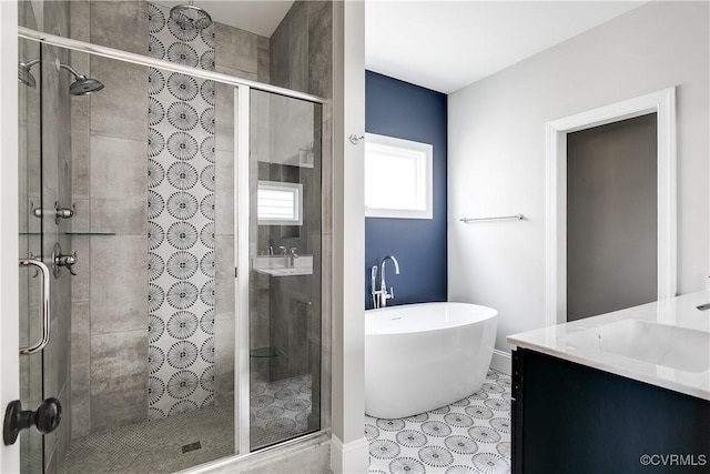 bathroom featuring a freestanding bath, a stall shower, and vanity