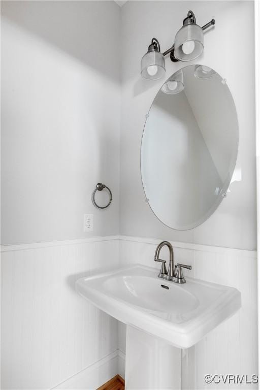 bathroom with wainscoting and a sink