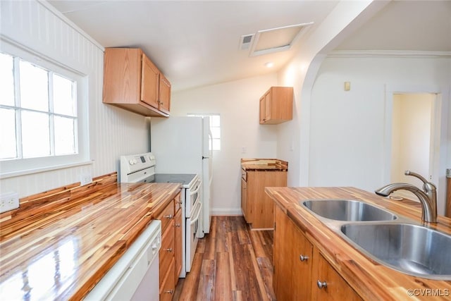 kitchen featuring white appliances, visible vents, wood counters, dark wood-style flooring, and a sink