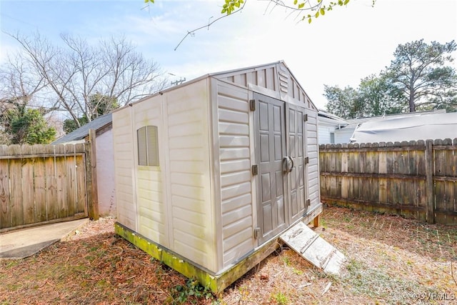 view of shed featuring a fenced backyard