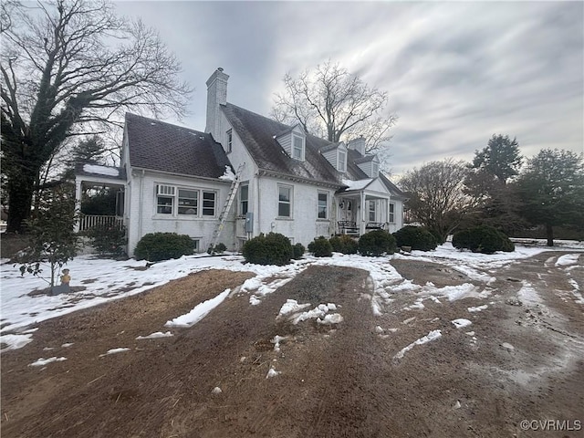 snow covered property with a porch