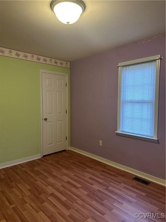 spare room featuring hardwood / wood-style flooring