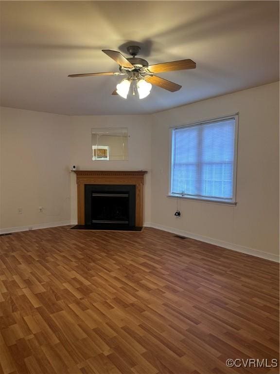 unfurnished living room with hardwood / wood-style flooring and ceiling fan