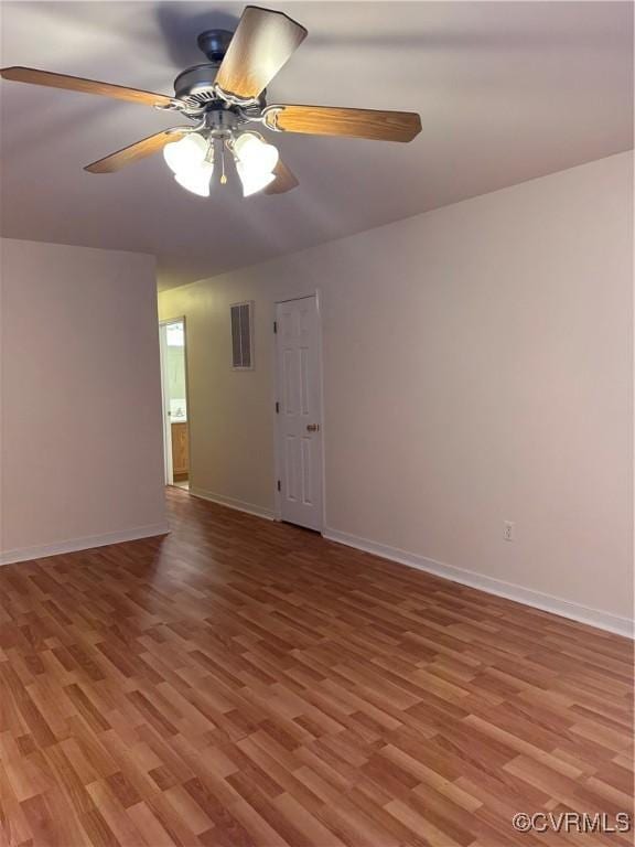 spare room featuring hardwood / wood-style floors and ceiling fan