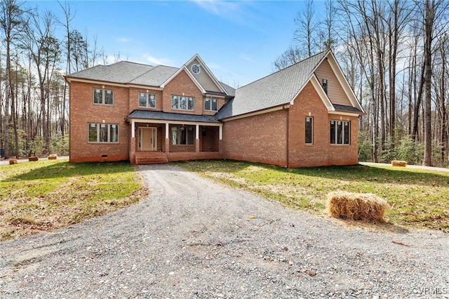 traditional-style house featuring crawl space, a front yard, and brick siding