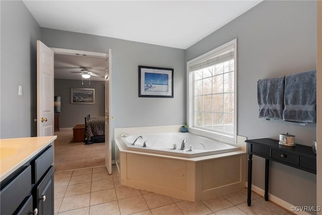 bathroom featuring tile patterned floors, ceiling fan, a bathtub, and vanity