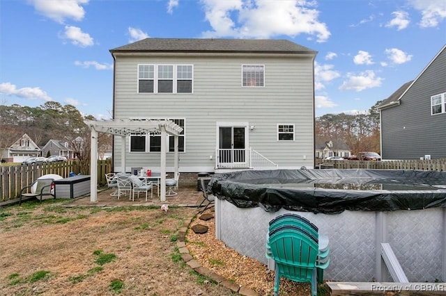 back of house featuring a patio area, fence, a fenced in pool, and a pergola