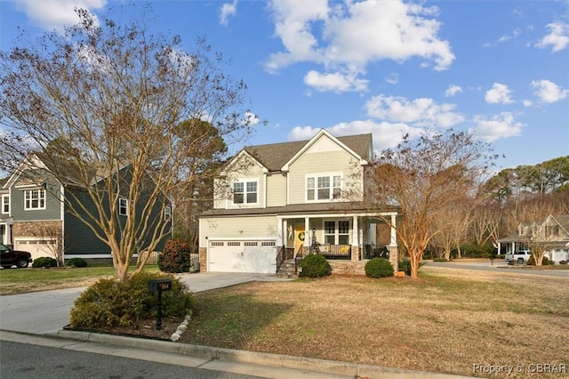 view of front of house with driveway, a garage, a porch, and a front yard