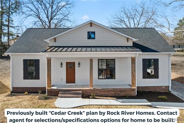 view of front of house with covered porch, metal roof, a shingled roof, and a standing seam roof